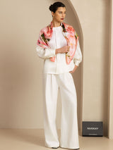 Pink floral print mulberry silk scarf draped over white outfit