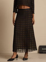 High-waist black silk A-line skirt with textured grid pattern and tea-length silhouette