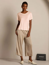 Light blush silk jersey short sleeve round neck T-shirt with beige wide-leg pants