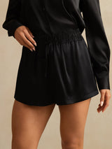 Black silk high-waist A-line shorts with shirred drawstring waistband