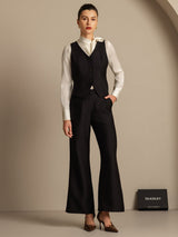 Black silk-wool blend V-neck vest with button front, styled with white blouse and wide-leg pants