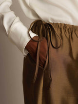 Brown silk-wool straight-leg pants with drawstring waist and side pockets