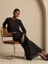Model wearing a pure silk high-waist A-line textured grid long skirt in black