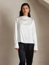 White silk long sleeve boat neck blouse with pearl shoulder buttons and wide cuffs