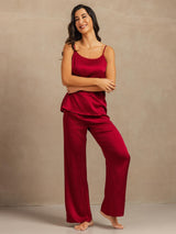 Red silk spaghetti strap cami and wide leg pants pajama set on model