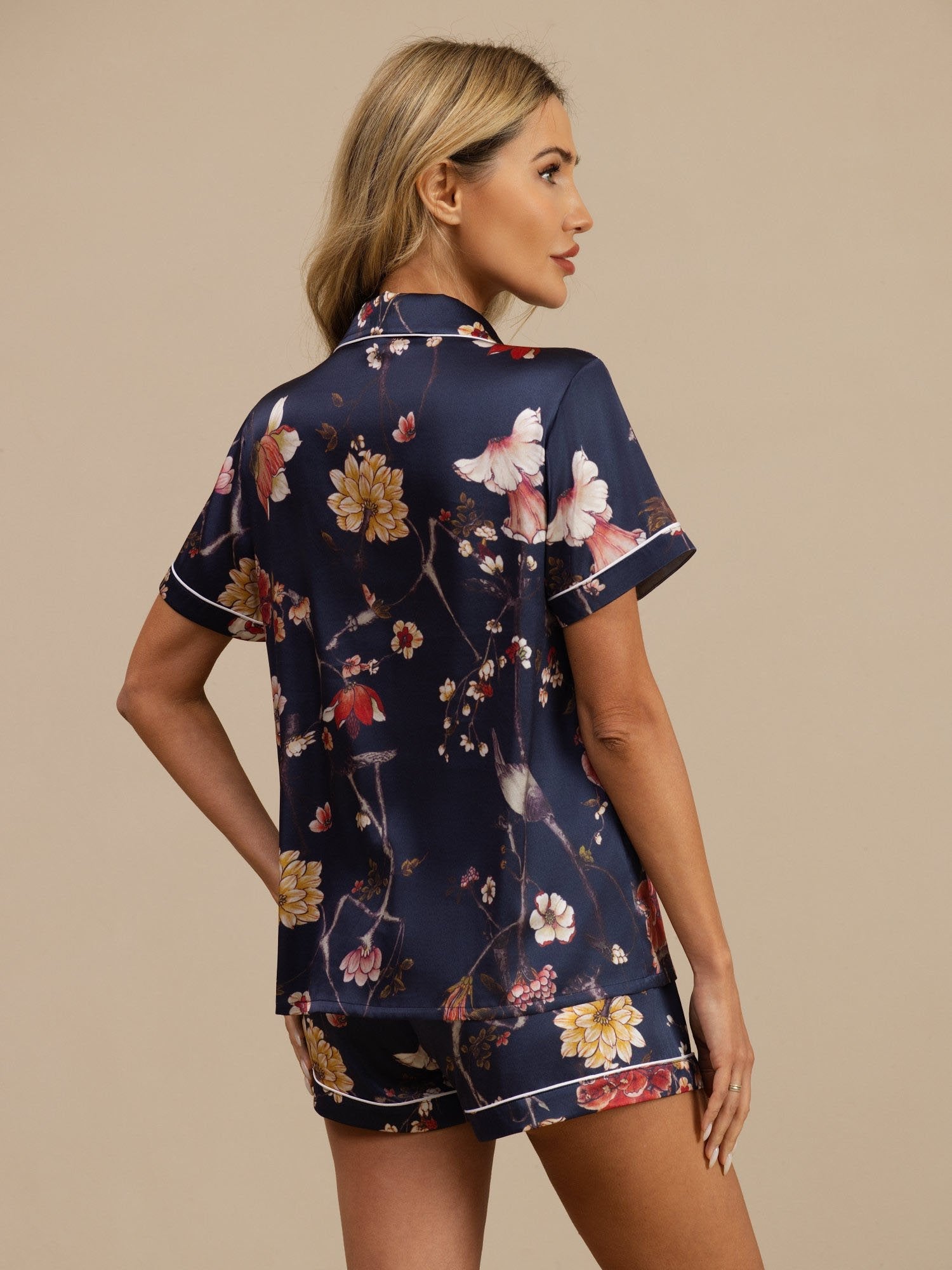 Navy floral print silk pajama set with short sleeve notch collar top and shorts