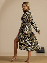 Woman wearing a pure silk leopard print midi robe with belted waist and long sleeves