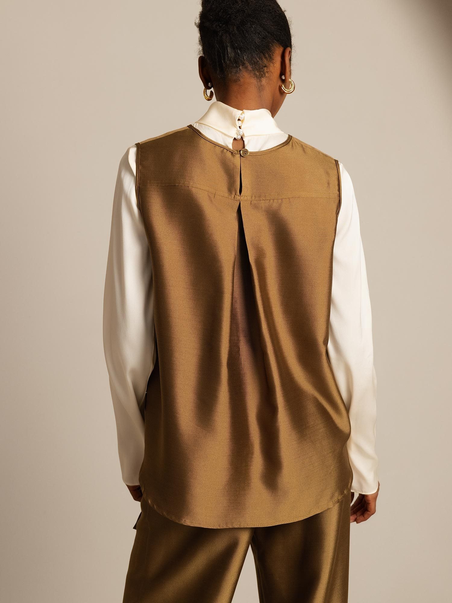 Back view of silk-wool blend women's vest with button-back closure in brown