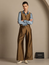 Model wearing silk wool blend wide-leg pants with blue shirt and vest