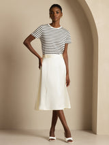 White high-waist A-line midi silk skirt with side pockets, shown on model