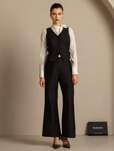 Black silk-wool blend women's V-neck vest with button detail, paired with wide-leg pants