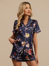 Navy floral print silk pajama set with notch collar, short sleeves, and button-up top