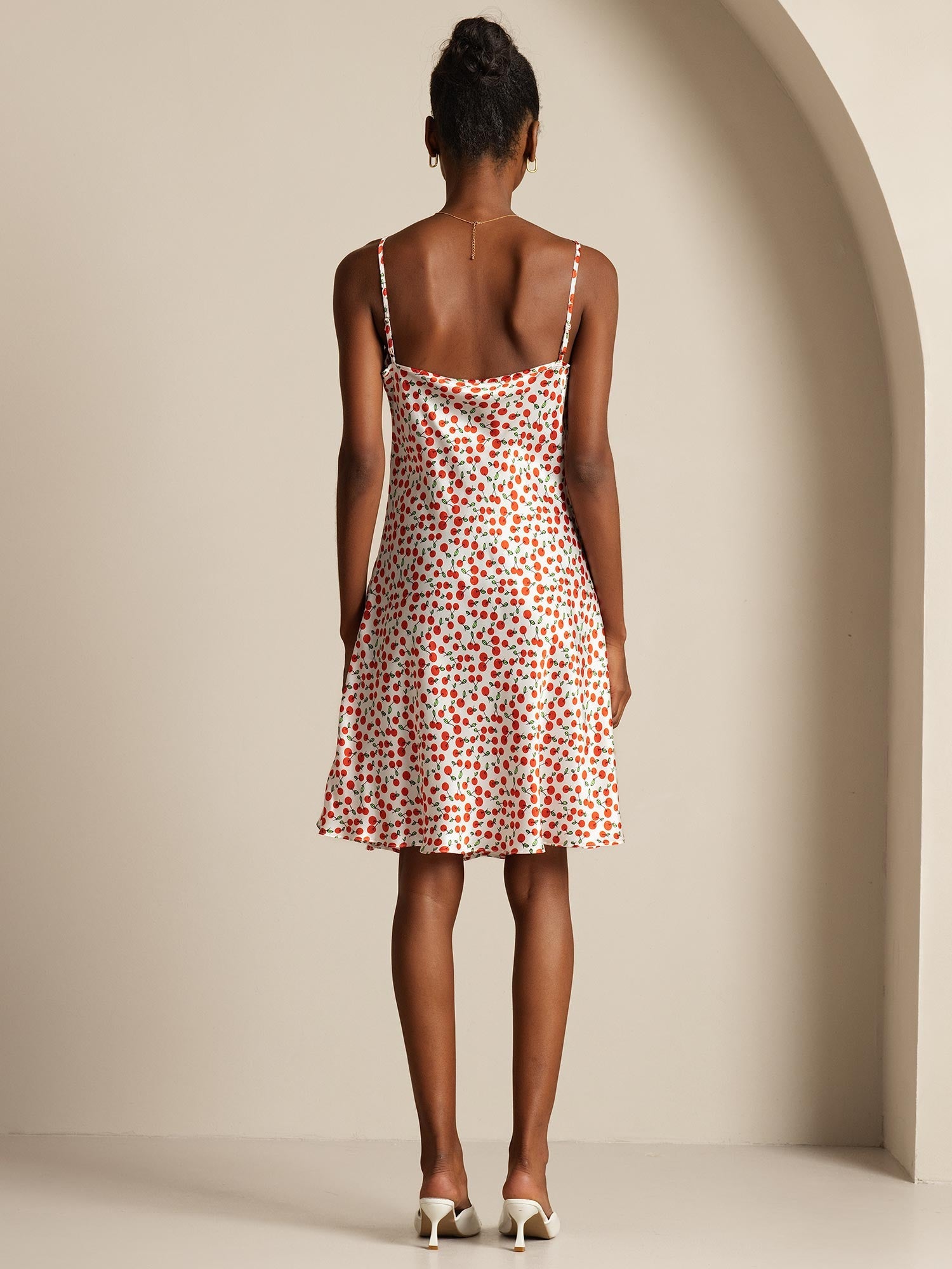 Back view of a cherry print silk blend spaghetti strap dress with straight fit