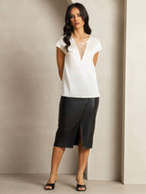 White silk cap sleeve top with sheer V insert and black midi skirt