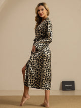 Woman wearing a pure silk leopard print midi robe with long sleeves and belted waist