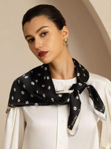 Black 100% mulberry silk paw print square scarf worn as a neck scarf