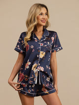 Navy floral silk pajama set with short sleeve notch collar top and drawstring shorts