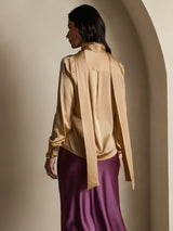 Champagne silk high-neck blouse with oversized bow tie and long sleeves