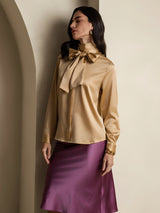 Champagne silk high-neck blouse with oversized bow and long sleeves