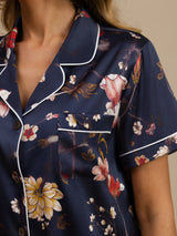 Navy floral silk pajama top with notch collar, white piping, and chest pocket