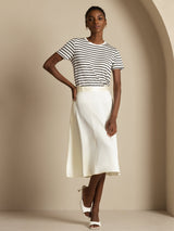 White high-waist A-line midi silk skirt with pockets, paired with striped tee