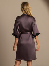 Back view of a plum silk robe with lace-trimmed sleeves and self-tie belt