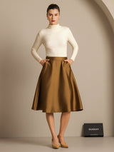 Camel-brown silk-wool blend A-line midi skirt with side pockets on model