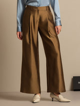 Model wearing brown silk-wool blend high waist wide-leg pants with side pockets
