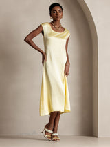 Pale yellow silk midi dress with round neck, cap sleeves, and straight fit