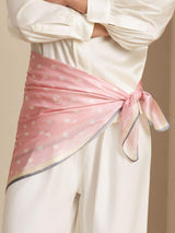 Pink mulberry silk paw print square scarf worn as a waist wrap