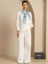 Model wearing white silk lounge set with light blue neck scarf