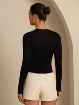 Black silk jersey long sleeve mock neck top on model, slim fit back view