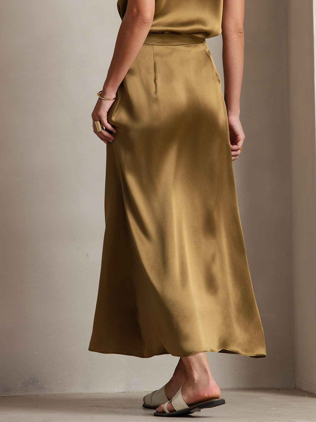 Silk A-line maxi skirt in gold with smooth drape and side zip