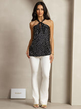 Black silk halter top with white polka dots, twist-front keyhole neckline and straight hem