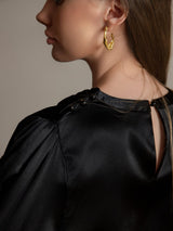 Black silk long sleeve boat neck blouse with pearl shoulder buttons and back keyhole closure