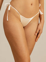 White silk tie-side thong bikini panty with low-rise fit and minimal coverage
